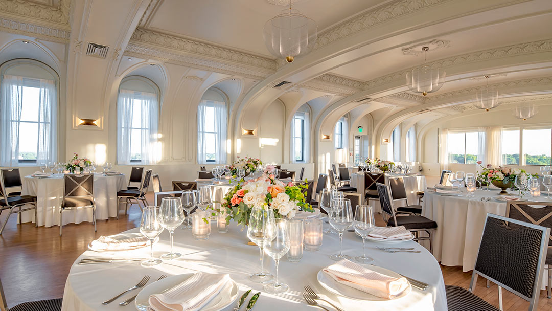 historic ballroom decorated with floral centerpieces