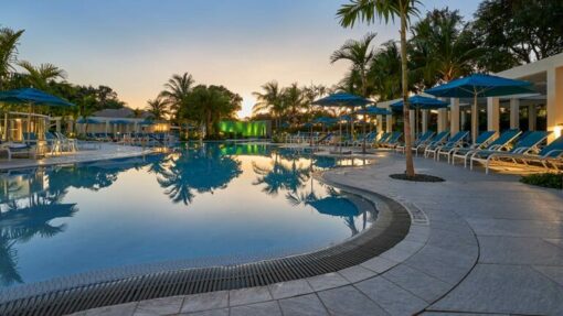 pool at dusk with umbrellas