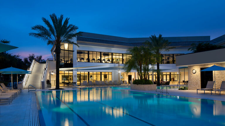 exterior view at dusk pool with new fitness complex