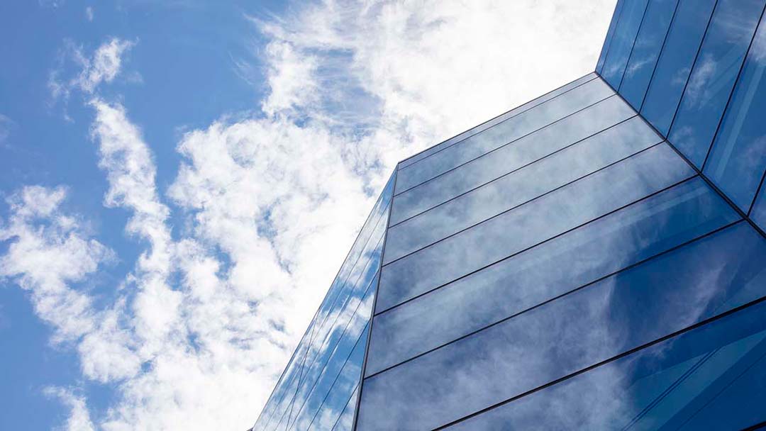 Clouds reflecting in angled glazing